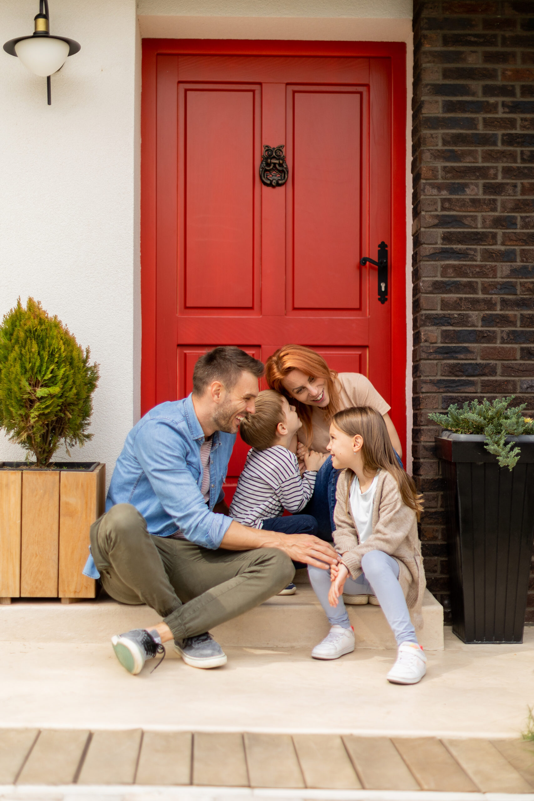 family with a mother, father, son and daughter sitting outside o